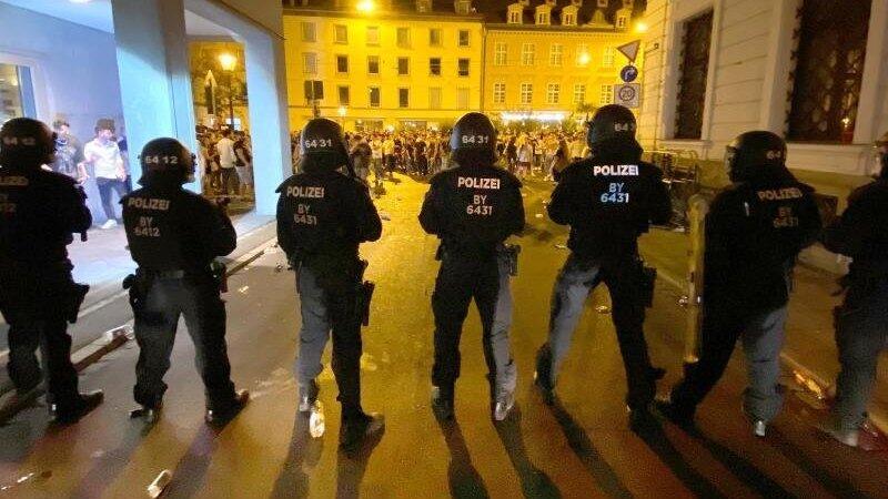 Polizisten stehen an einem Platz in der Innenstadt, wo sich Menschen zum Feiern versammelt haben. Polizisten stehen an einem Platz in der Innenstadt, wo sich Menschen zum Feiern versammelt haben.