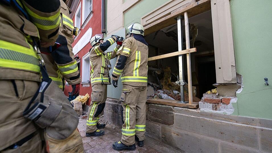 Einsatzkräfte der Feuerwehr sichern die Wand, in der ein großes Loch klafft. Einsatzkräfte der Feuerwehr sichern die Wand, in der ein großes Loch klafft.
