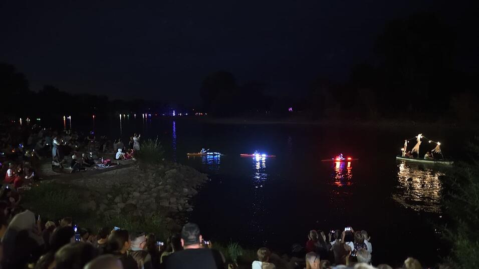 Bunt beleuchtete Boote fahren bei der Lampionfahrt über die Donau.