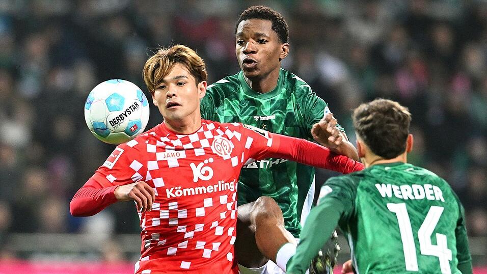 Kaishu Sano (l) von Mainz 05 wird von den Bremern Skelly Alvero (M) und Senne Lynen bedr&auml;ngt.