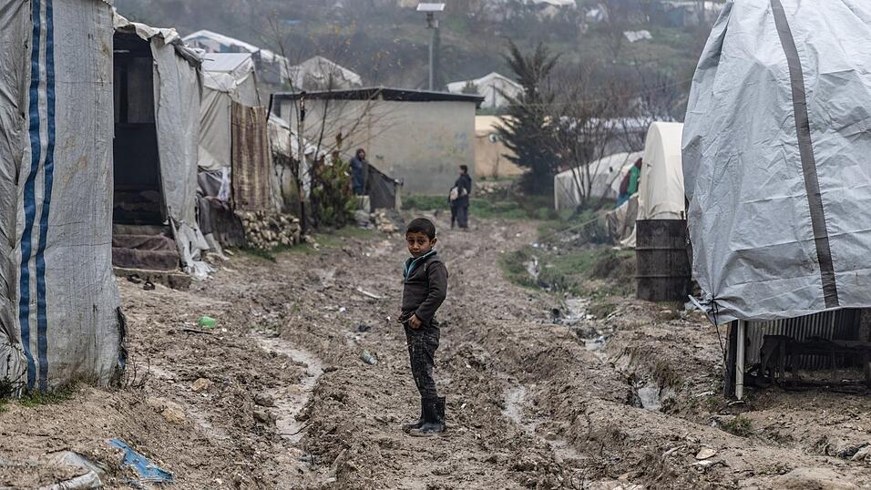 Ein kleiner Junge steht auf schlammigem Boden in dem Flüchtlingslager im Norden Syriens nahe der syrisch-türkischen Grenze.