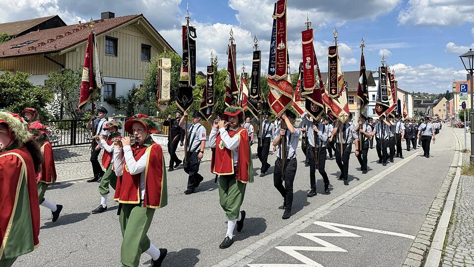 Stadtspielmannszug und das Fahnenmeer der beteiligten Feuerhwehren beim Umzug.