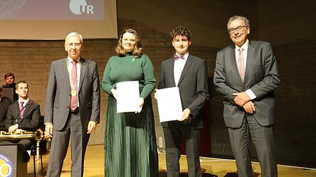 Udo Hebel (links) und Peter Küspert (rechts) überreichten den Preis für studentisches Engagement an Madeleine Schneider und Tim Oberding.