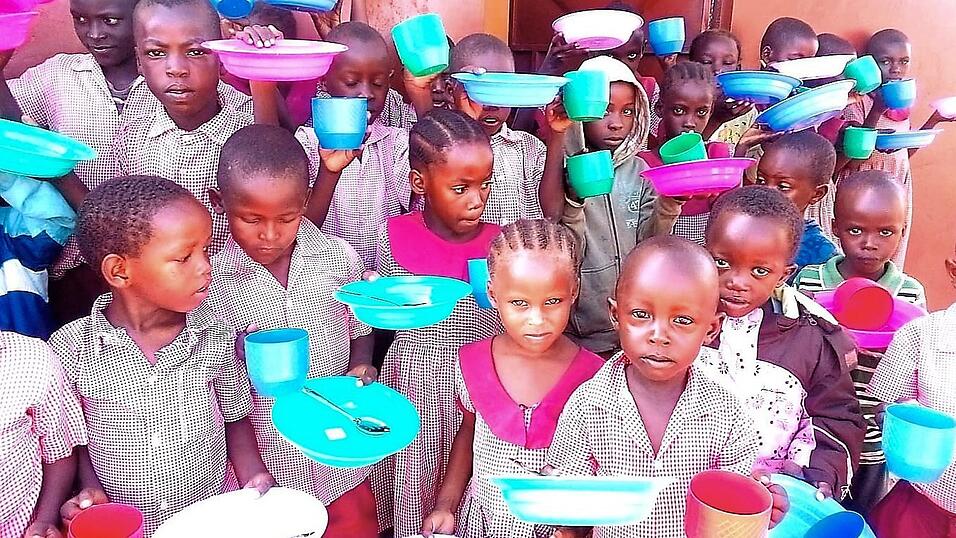 Kinder in Shirango mit dem neuen Geschirr warten auf das Frühstück. Kinder in Shirango mit dem neuen Geschirr warten auf das Frühstück.