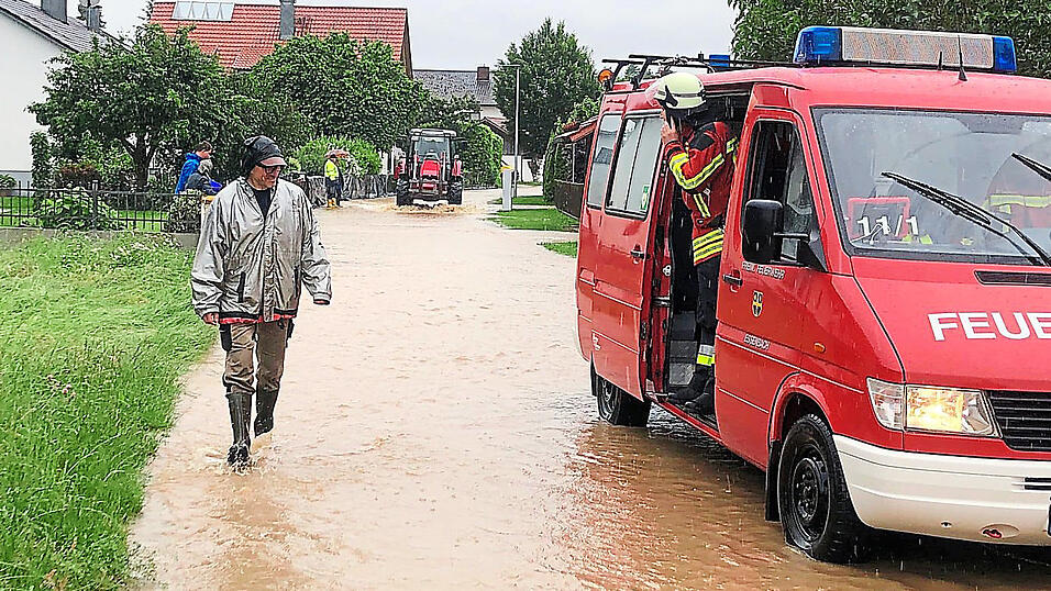 In Unterunsbach hat der Regen die Straßen geflutet. Feuerwehrler und Anwohner packen mit an. In Unterunsbach hat der Regen die Straßen geflutet. Feuerwehrler und Anwohner packen mit an.