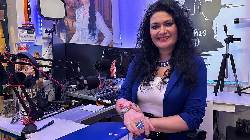 Christl Fischer sitzt in ihrem Studio, in dem sie ihre Radiosendung moderiert. Ihr gro&szlig;er Ring und die Sakkofarben verraten die Partei: Fischer ist die AfD-Landratskandidatin.