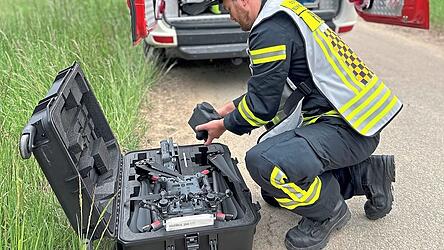 Ein Feuerwehrmann bereitet die Drohne für die Vermisstensuche vor.