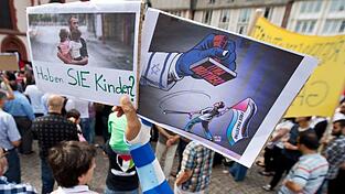 Ein Junge hält ein Plakat hoch, auf dem ein propalästinensischer Demonstrant unter einem Stempel mit der Aufschrift «Anti Semitismus» steht. Ein Junge hält ein Plakat hoch, auf dem ein propalästinensischer Demonstrant unter einem Stempel mit der Aufschrift «Anti Semitismus» steht.