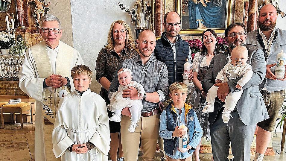 Pfarrer Wutz, Ministrant Tobias V&ouml;lkl, Marie auf dem Arm ihres Paten mit Eltern und Bruder Max, Matteo auf dem Arm seines Paten, dahinter die Eltern.