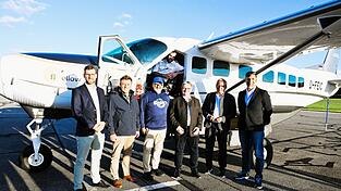 Im Licht der Abendsonne freuten sich über die neuen Angebote mit FlyvBird: Geschäftsführer Florian Kindzorra vom Airport Straubing, Bürgermeister Ewald Seifert aus Oberschneiding, Prof. Peter Schmieder vom BITZ Oberschneiding, Pilot Niki Paulweber, MdL Josef Zellmeier, Landrat Josef Laumer und FlyvBird-Chef Tomislav Lang (von links).