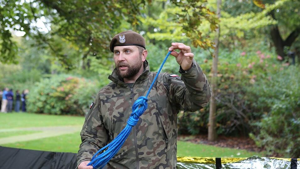 Soldat Michal Szubert von Polens Territorialstreitkräften erklärt, die man sich draußen schützen kann. Soldat Michal Szubert von Polens Territorialstreitkräften erklärt, die man sich draußen schützen kann.