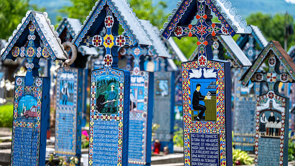 Die blauen Kreuze auf dem &bdquo;Fr&ouml;hlichen Friedhof&ldquo; des nordrum&auml;nischen Dorfes Sapanta. Der Holzbildhauer Stan Ioan Patras hatte 1935 die Idee, das Leben und die Pers&ouml;nlichkeit der Verstorbenen in einer fr&ouml;hlichen Darstellung zu zeigen und Eigenheiten in einem Reim auf humorvolle Weise zu beschreiben.