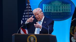 US-Pr&auml;sident Donald Trump tut w&auml;hrend einer Pressekonferenz so, als ziele er mit einem Scharfsch&uuml;tzengewehr. (Symbolbild)