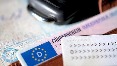 Ein F&uuml;hrerschein, ein Autoschl&uuml;ssel, ein Personalausweis und eine Zulassungsbescheinigung liegen auf einem Portemonnaie. Aktuell &auml;chzt die F&uuml;hrerscheinstelle unter dem Ansturm von B&uuml;rgern, die knapp vor Ablauf der Frist ihren F&uuml;hrerschein gegen die aktuelle Version tauschen wollen. Es kommt zu Engp&auml;ssen, die die Betroffenen ver&auml;rgern.