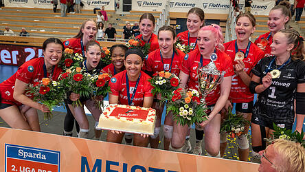 Blumen, Torte, Goldmedaillen und der &bdquo;Pott&ldquo;: Die M&auml;dels der Roten Raben Vilsbiburg bejubeln nach der Meister-Kr&ouml;nung vor &uuml;ber 1.500 Fans in der Ballsporthalle den Titelgewinn in der 2. Liga Pro. Jetzt fehlt blo&szlig; noch die Lizenz f&uuml;rs deutsche Volleyball-Oberhaus.