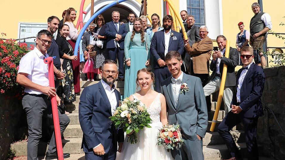 Für Monika und Stefan Preiß gab es nach dem Gottesdienst einen Empfang von der DLRG Blaibach, Vorsitzender Alexander Engl (l.) übergab einen Blumenstrauß.