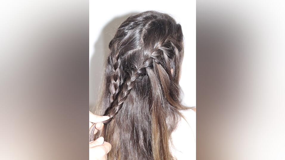 Auch den zweiten Zopf fixiert ihr mit einem Haargummi. Auch den zweiten Zopf fixiert ihr mit einem Haargummi.