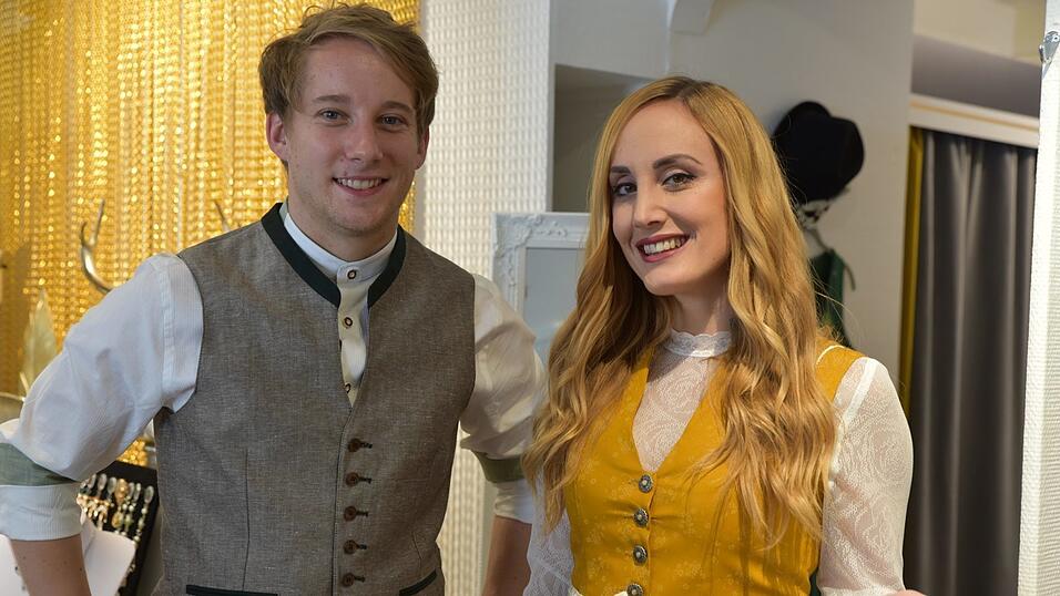 Das senfgelbe Dirndl trägt man beispielsweise in Kombi mit einer langärmeligen Spitzenbluse. Das Outfit in Lederhose & Co. ist farblich abgestimmt.