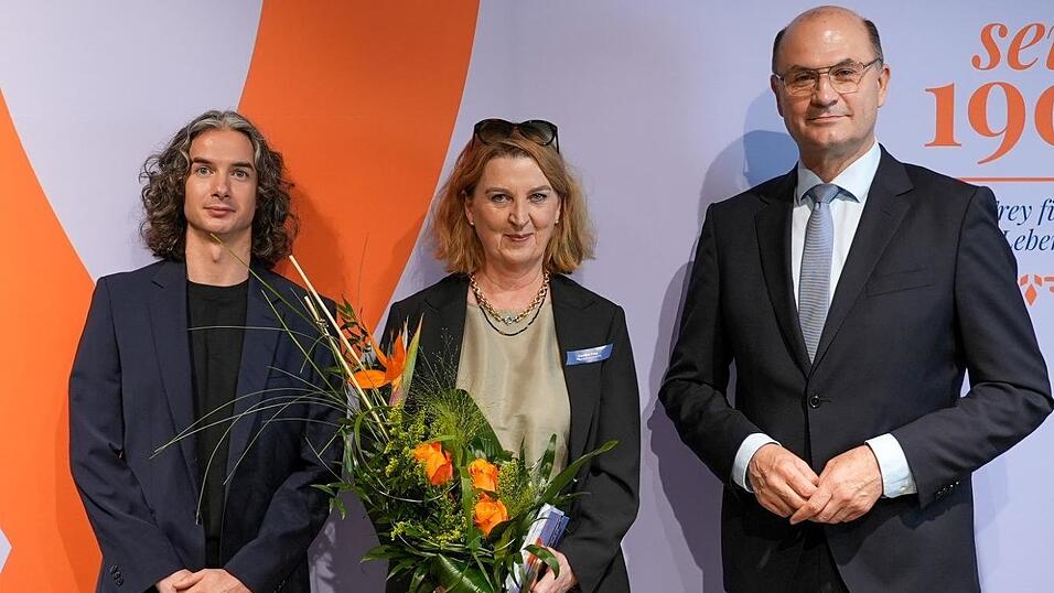 Finanzminister Albert F&uuml;racker l&auml;sst Blumen sprechen, um Caroline und Amran Frey zu gratulieren.