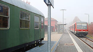 Rechts steht eine Garnitur der heutigen Gäubodenbahn bereit zur Abfahrt in Richtung Neufahrn. Links zu sehen ist der alte Waggon, der von der Stadt zu einer Radlerpension umgebaut wurde. Er stammt aber nicht mehr von der einstigen Linie nach Miltach.