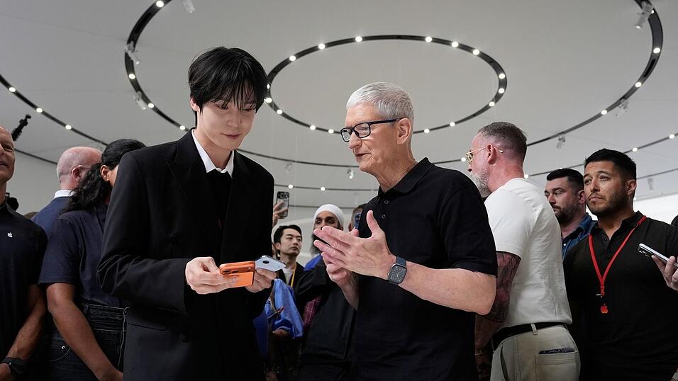 2026: Apple Chef Tim Cook (M) steht unter Druck, ein neues gro&szlig;es Ding - &laquo;One More Thing&raquo; abzuliefern.