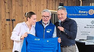 Jule Schneider und Gerd Sch&ouml;nfelder (r.) &uuml;berreichen OK-Chef Anton Wittenzellner eine der neuen Skijacken f&uuml;r die Parasportler, die letztes Jahr mithilfe der Rotarier-Spenden angeschafft wurden.