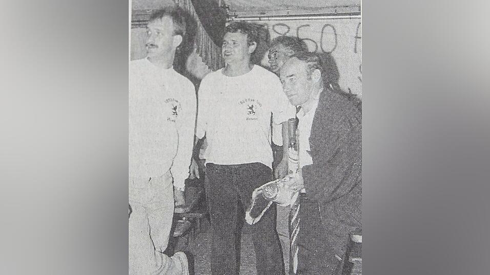 Karsten Wettberg im Juni 1991 nach dem Prominentenspiel im Festzelt. Zu sehen ist er hier mit Vertretern des 1860-Fanclubs Wiesent, die ihm einen Wimpel samt Bierkrug schenkten - und einen Regenschirm, nachdem er seinen eigenen beim Aufstieg zertr&uuml;mmert hatte.