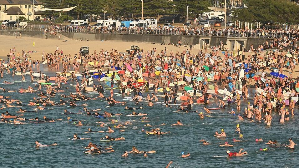Surfer gedenken am Bondi Beach der Terroropfer. Surfer gedenken am Bondi Beach der Terroropfer.