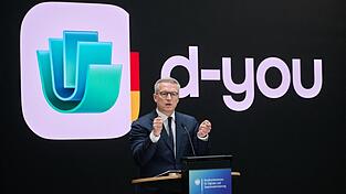 Wer sein Smartphone ab dem kommenden Jahr auch als Ausweis nutzen will, braucht dafür eine App namens 'd-you'. Bundesdigitalminister Karsten Wildberger (CDU) stellt Name und Design der Anwendung vor. Wer sein Smartphone ab dem kommenden Jahr auch als Ausweis nutzen will, braucht dafür eine App namens 'd-you'. Bundesdigitalminister Karsten Wildberger (CDU) stellt Name und Design der Anwendung vor.
