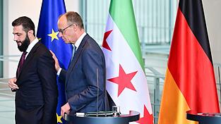 Wer hat die 80-Prozent-Zielmarke genannt, Syriens &Uuml;bergangspr&auml;sident Ahmed al-Scharaa oder Kanzler Friedrich Merz (CDU)? Nicht so wichtig, meint die Bundesregierung.