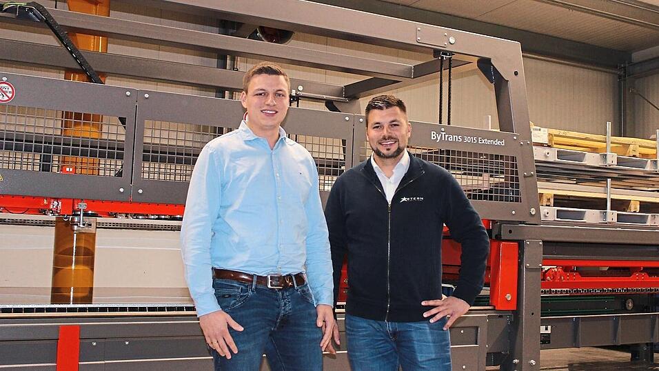 Die beiden Gesch&auml;ftsf&uuml;hrer Michael Stern (v.li.) und Florian Rabenbauer vor der neu angeschafften Faserlaseranlage.