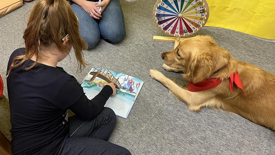 Die neun Jahre alte Jasmin liest Bucky die Geschichte von der kleinen Meerjungfrau vor.