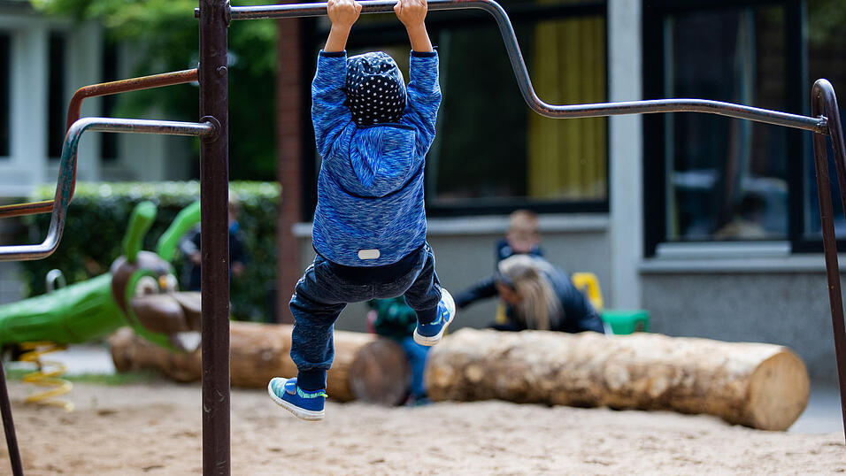 Ein Kind spielt auf dem Spielplatz einer Kindertagesst&auml;tte. Zur Anzahl der Erzieher und Kinderpfleger in seiner Gruppe haben Kommunen, Freistaat, Bund die Bertelsmann-Stiftung unterschiedliche Ansichten.