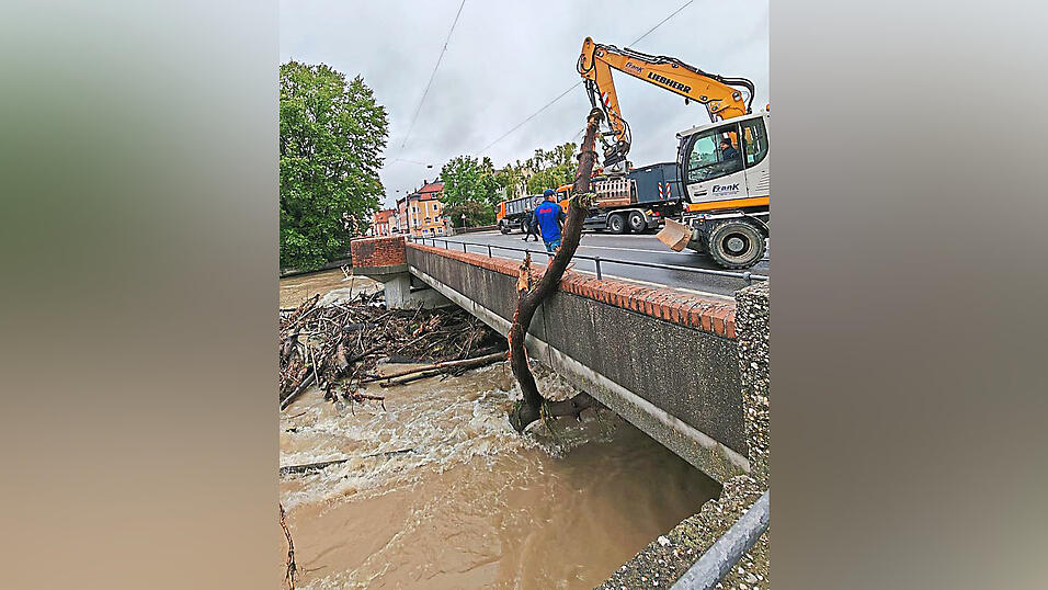 Ein Bagger hievt an der Heilig-Geist-Brücke Treibgut aus der Isar. Ein Bagger hievt an der Heilig-Geist-Brücke Treibgut aus der Isar.