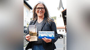Astrid Piermeier mit Busfahrplan und Wanderkarte