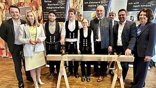 Handwerk trifft Politik: Kultusministerin Stolz mit den Landtagsabgeordneten Dr. Hopp und Preidl, Landrat L&ouml;ffler und B&uuml;rgermeister Bauer zusammen mit Rosi Tragl-Kraus, Gesch&auml;ftsf&uuml;hrerin der Kreishandwerkerschaft, und drei jungen Schreinern.