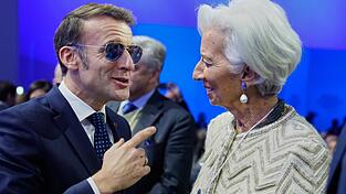 Der franz&ouml;sische Pr&auml;sident Emmanuel Macron (wegen einer Augenverletzung mit Sonnenbrille) spricht mit EZB-Pr&auml;sidentin Christine Lagarde w&auml;hrend der Jahrestagung des Weltwirtschaftsforums.