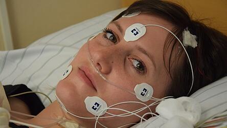 Nina Effhauser zeigt, wie man f&uuml;r eine Nacht im Schlaflabor des Bezirksklinikums Regensburg verkabelt wird. Sie ist dort medizinische Fachangestellte.