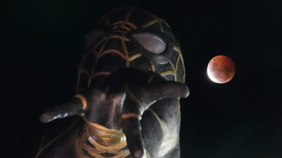 Während der partiellen Mondfinsternis geht in El Alto, Bolivien, der Mond hinter einer Spider-Man-Statue auf. Während der partiellen Mondfinsternis geht in El Alto, Bolivien, der Mond hinter einer Spider-Man-Statue auf.