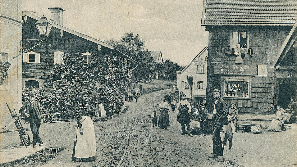 Die Ansichtskarte von Perlesreut (Landkreis Freyung-Grafenau) zeigt den Laden des Uhrmachers und Goldwarenh&auml;ndlers Anton Bogenst&auml;tter samt Familie und vermutlich anderen Marktbewohnern.