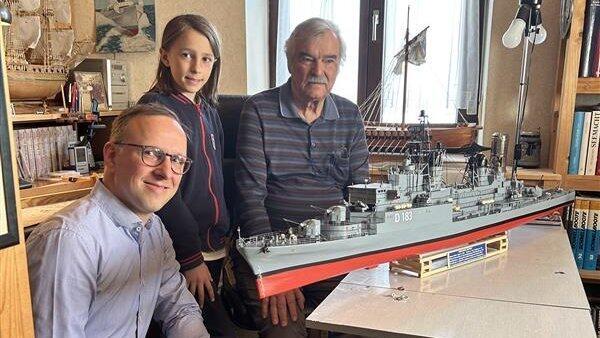 Auftraggeber Tim Klusmann (v.l.) und sein Sohn Jakob waren begeistert von Walter Baumanns Modell des &bdquo;Zerst&ouml;rer Bayern'.