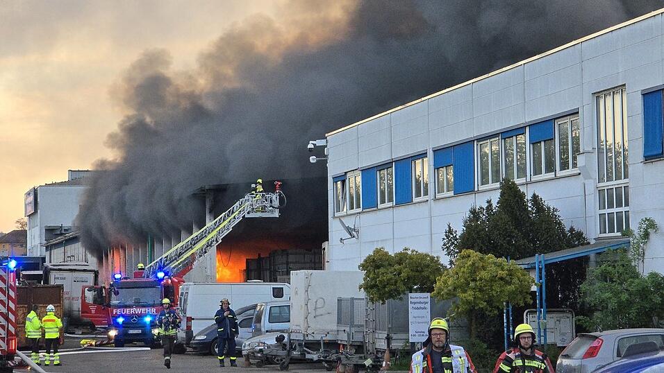 Eine riesige dunkle Rauchwolke war am Freitagabend zu sehen, weil eine Lagerhalle in Regensburg brannte. Eine riesige dunkle Rauchwolke war am Freitagabend zu sehen, weil eine Lagerhalle in Regensburg brannte.