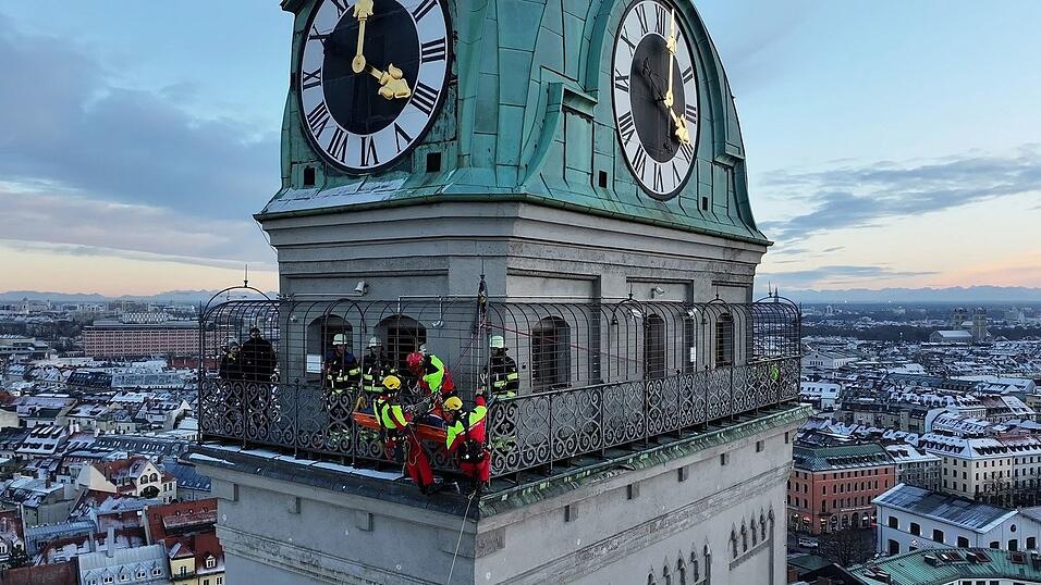 Kräfte der Berufsfeuerwehr München sind am Turm der Kirche St. Peter im Einsatz.