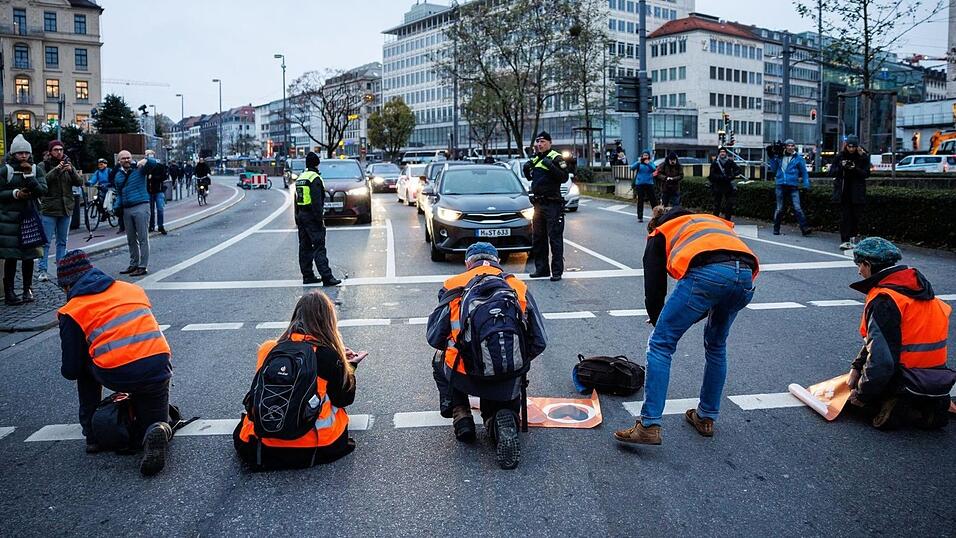 Aktivisten der Klimaschutz-Initiative 'Letzte Generation' kleben sich am Stachus mit ihren Händen auf die Straße. Am Montag kam es auch in Passau zu einer neuerlichen Aktion von Klimaaktivisten (Symbolbild).