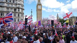 Union Jacks, Flaschenwürfe und Slogans gegen Migration: Eine Demonstration in London zieht Massen von Menschen an.