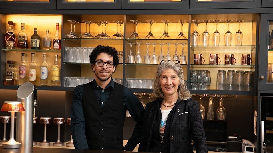 Barchef Alexander Dindar hinterm Tresen, Hotelchefin Kathrin Fuchshuber gesellt sich zu ihm.