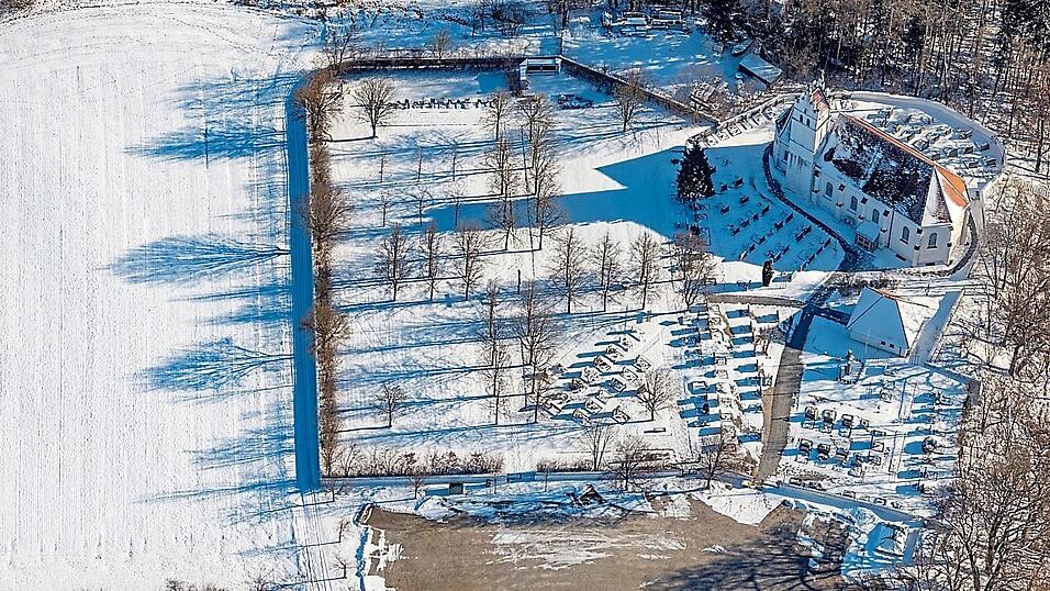 Der winterliche Friedhof aus der Luft mit den beiden Teilen von Kirche und Gemeinde und der Kirche St. Ulrich. Der winterliche Friedhof aus der Luft mit den beiden Teilen von Kirche und Gemeinde und der Kirche St. Ulrich.