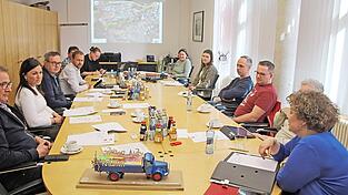 Eventmanager Sebastian Gabler (hinten links) und B&uuml;rgermeisterin Alexandra Riedl (vorne rechts) informieren &uuml;ber den Veranstaltungsreigen in Roding vor dem Ausschuss f&uuml;r Kultur, Sport, Jugend, Soziales. Im Vordergrund der von Architekt Florian Brunner entworfene Umzugswagen der Stadt.