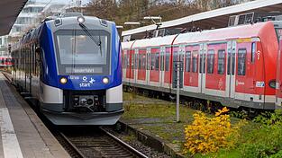 Der 'Wasserstoffzug' steht neben einer konventionellen S-Bahn.