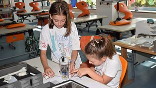Antonia (l.) und Alina bauen einen Bionic-Fisch. Mit Hilfe eines Mikrocontrollers können Effekte wie der Flossenstrahl simuliert werden.